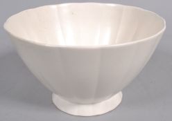 A Wedgwood flared fluted bowl by Keith Murray, glazed in white, printed blue and impressed marks,