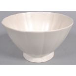 A Wedgwood flared fluted bowl by Keith Murray, glazed in white, printed blue and impressed marks,