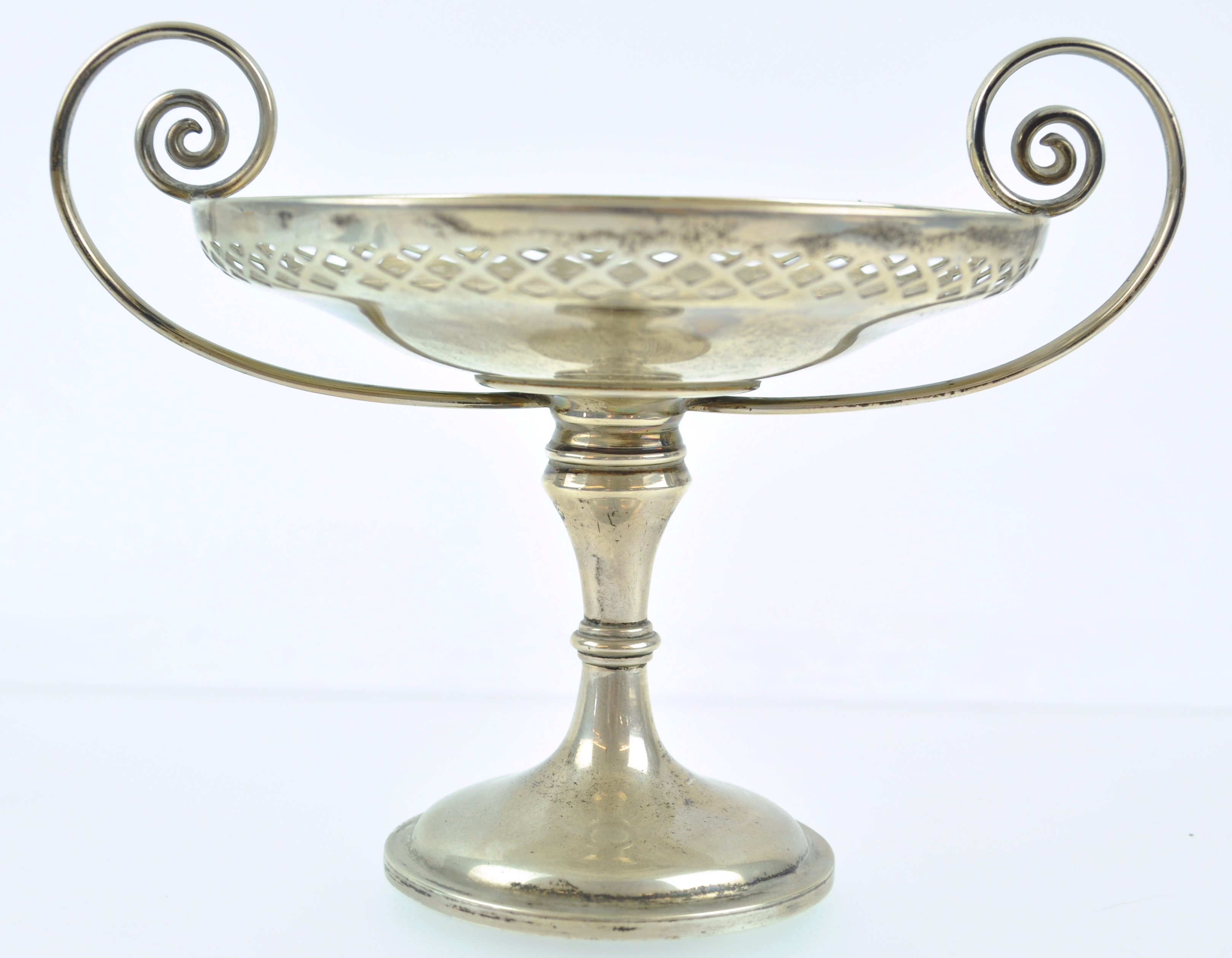 A tall silver two handled bon bon dish with pierced edge bowl on baluster stem and trumpet foot,