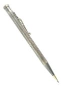 A yard'o'lead rolled silver propelling pencil with engine turned body,