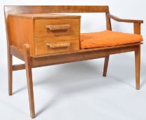 A 1960's retro vintage teak wood telephone table, with two drawers and adjacent seat,