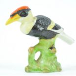 A Shelley model of a Hornbill, printed brown marks, Rd,645774, modelled perched on a tree-stump,