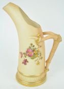 A Royal Worcester blush ivory Tusk style jug, decorated with a floral spray,