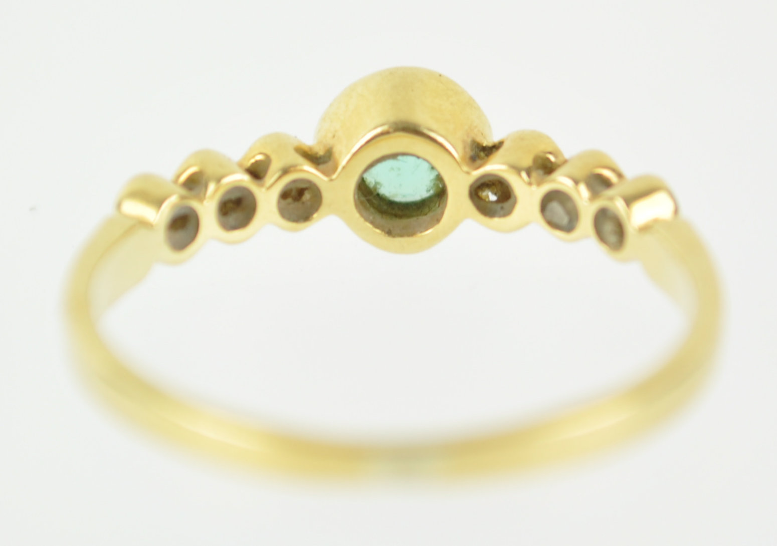 A yellow metal ring principally set with a round cut emerald and flanked by three diamonds to each - Image 5 of 6