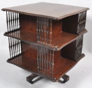 An Edwardian mahogany shaped revolving bookcase with turned spindles,