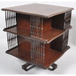 An Edwardian mahogany shaped revolving bookcase with turned spindles,