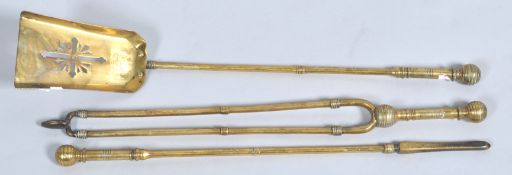A nest of three late 19th century brass fire irons,