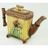 A 19th century majolica teapot, with moulded bamboo handle, the body decorated with birds,