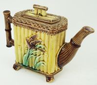 A 19th century majolica teapot, with moulded bamboo handle, the body decorated with birds,