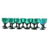 A group of twelve green glass wine glasses, circa 1800, with ogee bowls on plain stems and feet, 11.