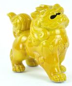 A 20th century Chinese porcelain dog of fo, yellow glazed,