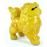 A 20th century Chinese porcelain dog of fo, yellow glazed,