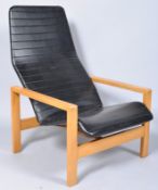 A 1970s retro vintage easy lounge chair/armchair having a ribbed vinyl upholstered seat and back