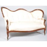 A Victorian mahogany show frame sofa with serpentine button back on cabriole legs with brass