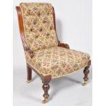 A Victorian nursing chair with upholstered back,