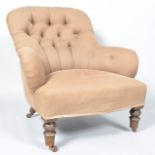 A Victorian button back nursing chair on turned legs and ceramic casters,