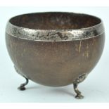 A George III style coconut bowl, with un-marked white metal mounts,