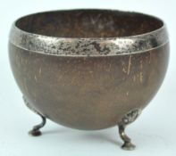 A George III style coconut bowl, with un-marked white metal mounts,