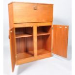 A 1950's 'Surline' cocktail cabinet with opening top above two doors,