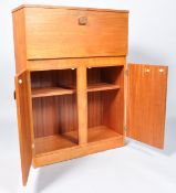 A 1950's 'Surline' cocktail cabinet with opening top above two doors,