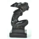 A French black pressed glass car mascot, the scantily draped female figure emblematic of wind,