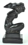 A French black pressed glass car mascot, the scantily draped female figure emblematic of wind,