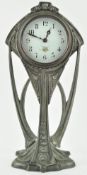 A Continental Art Noveau mantel clock, the dial printed with flowers in mixed metal case, 35.
