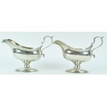 A pair of silver sauce boats, of neo classical bellied oval form,