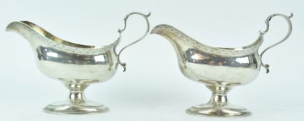 A pair of silver sauce boats, of neo classical bellied oval form,