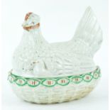 A Victorian Staffordshire pottery hen on a nest, picked out in coloured enamels, 18cm high,