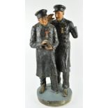 A patinated plaster figure of two vetran soldiers taking snuff,