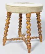 A Victorian stool with tapestry seat on later gold painted barley twist legs,