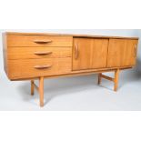 A 1960'S retro vintage teak wood sideboard credenza having three drawers adjacent to a twin