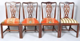 A set of four 20th century George III style mahogany dining chairs with pierced inter-linked splats,