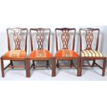 A set of four 20th century George III style mahogany dining chairs with pierced inter-linked splats,