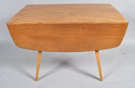 An Ercol style drop leaf table with elm top and splayed legs, 71cm high,