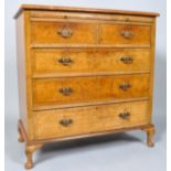 A walnut chest of two short and three long drawers, with brushing slide and carved cabriole legs,