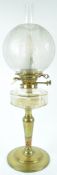 A late 19th century brass oil lamp with cut glass reservoir, chimney and etched globular shade,