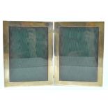 A white metal double photograph frame, marked Sterling,