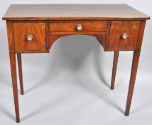 An early 19th century mahogany veneered three drawer sideboard, of small proportions,