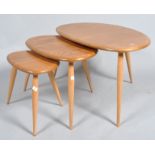An Ercol nest of three light elm and beech pebble shaped graduated sofa tables,