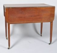 An Edwardian mahogany Pembroke table with box wood and ebony feather banding to the top,