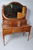 An Edwardian mahogany dressing table with shaped mirror,