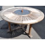 Neptune Classics; a contemporary teak wood garden table, of round form,