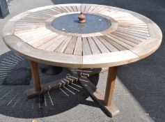 Neptune Classics; a contemporary teak wood garden table, of round form,