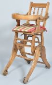 A 19th century metamorphic child's high/rocking chair, on cast iron wheels,