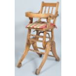 A 19th century metamorphic child's high/rocking chair, on cast iron wheels,