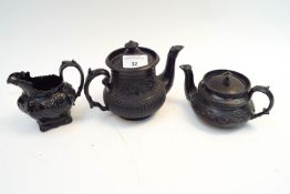 Three 19th century basalt pieces, to include a creamer and two miniature teapots,