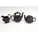 Three 19th century basalt pieces, to include a creamer and two miniature teapots,