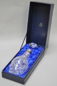 A boxed Garrard cut glass decanter with silver collar,